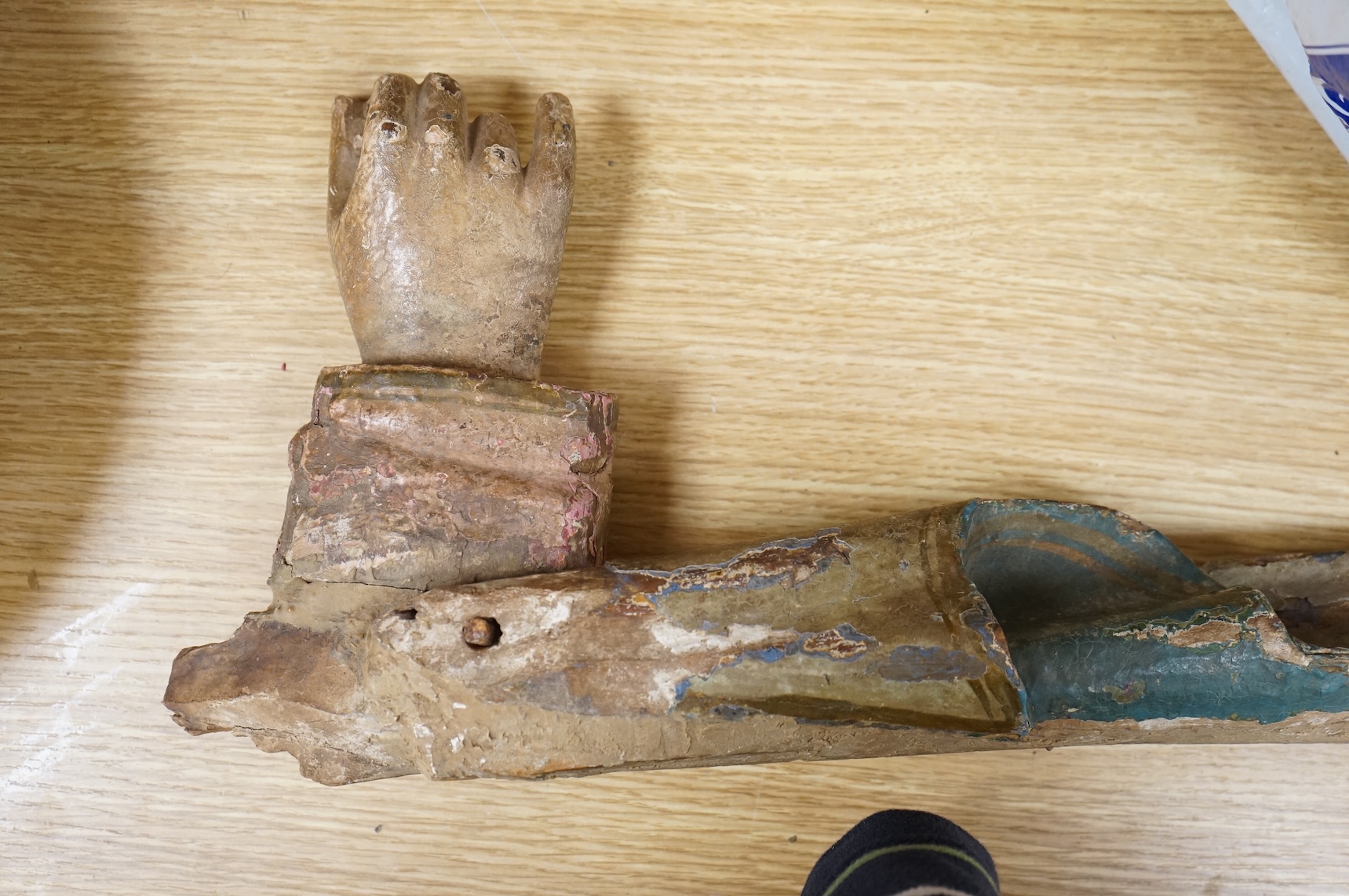 An 18th/19th century painted wood model of a Saint's arm, 56cm